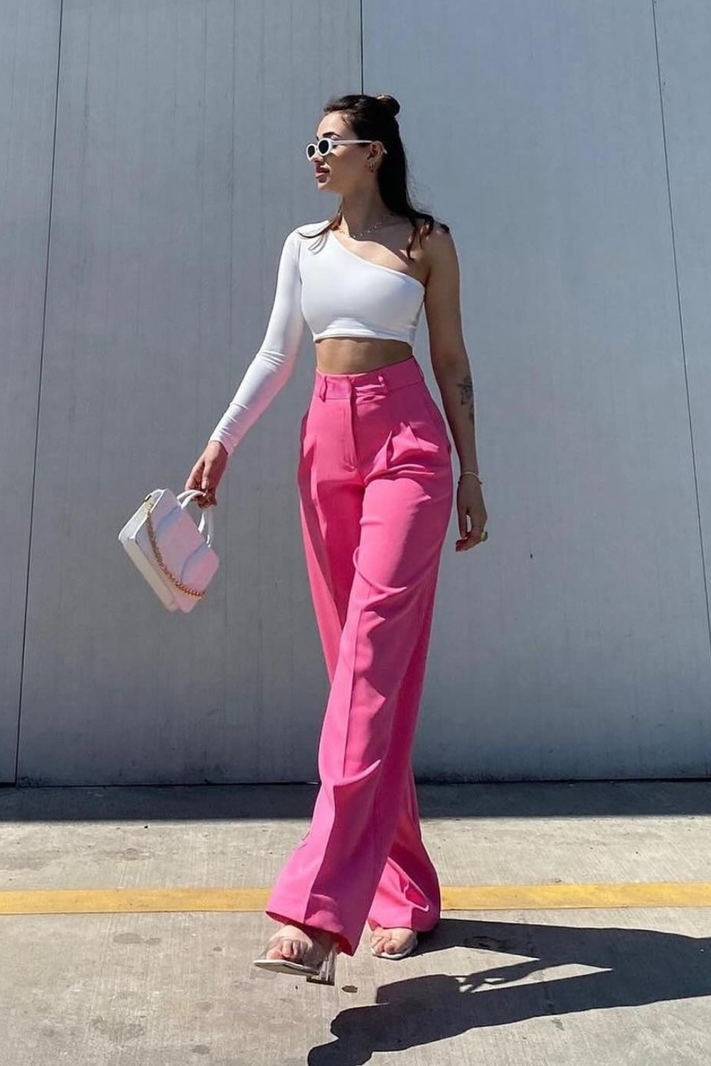 Asymmetrical Elegance: White One-Shoulder Top and Bright Pink Trousers