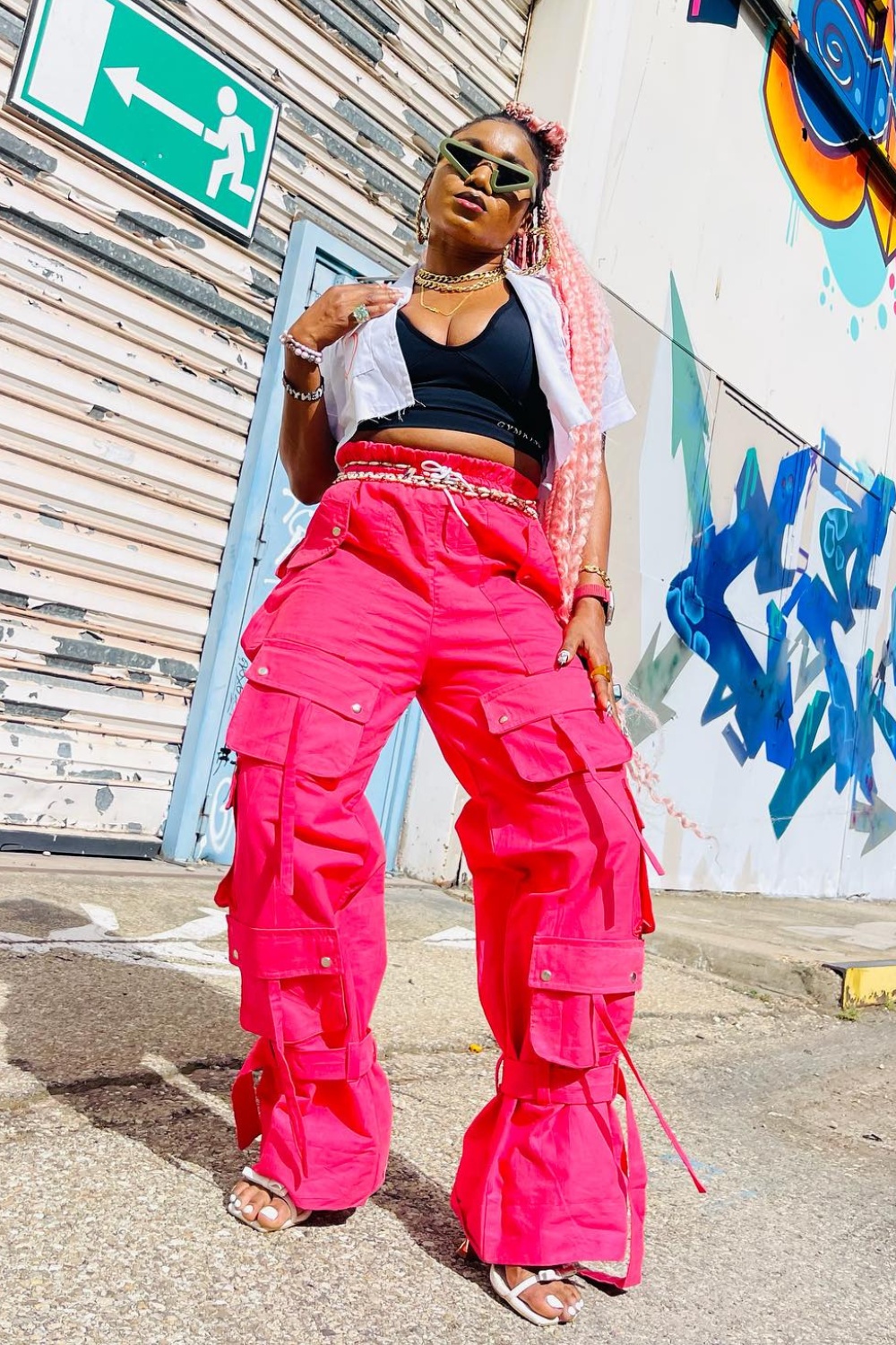 Layered Streetwear: Black Crop Top, White Shirt, and Hot Pink Cargo Pants