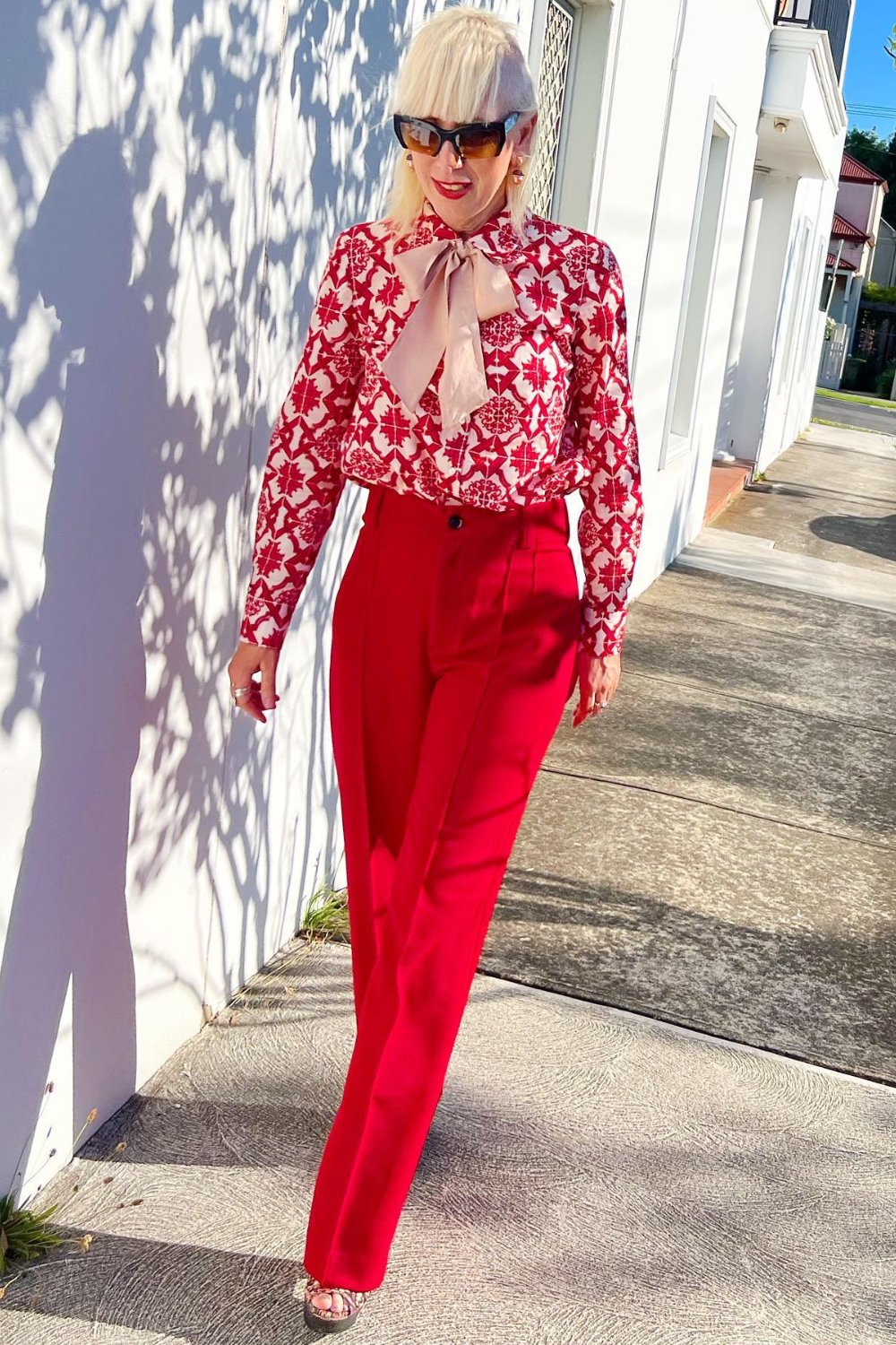 Printed Blouse and Red High-Waisted Trousers