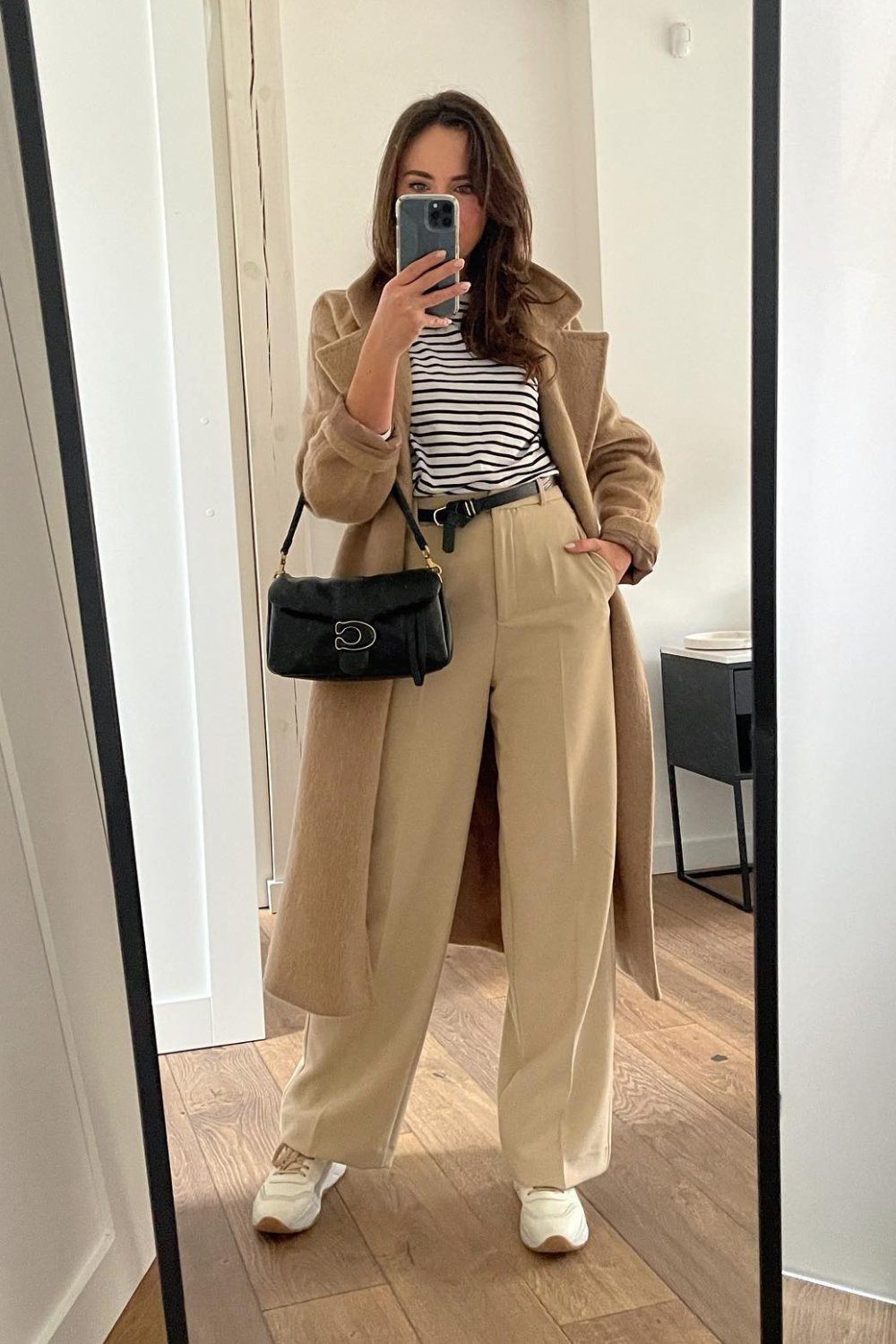 Striped turtleneck top with beige trousers and camel coat