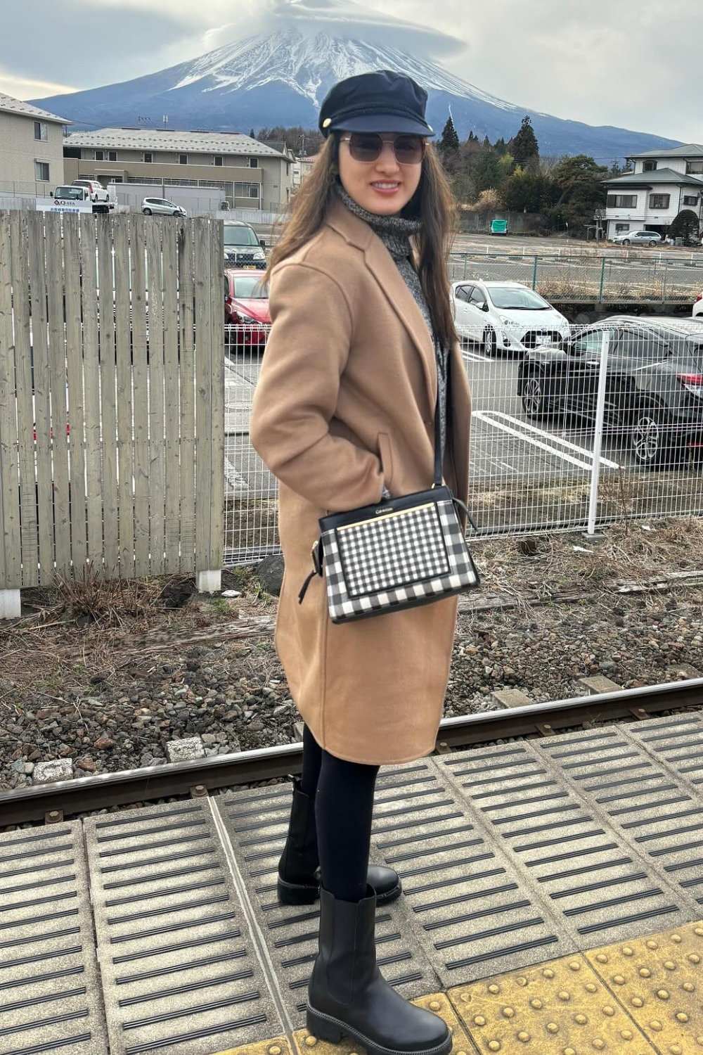 Camel Coat, Black Outfit, and Newsboy Cap