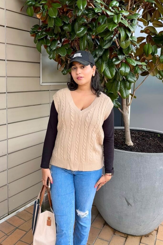 Sweater Vest, Long Sleeve Top, Jeans, and Baseball Cap