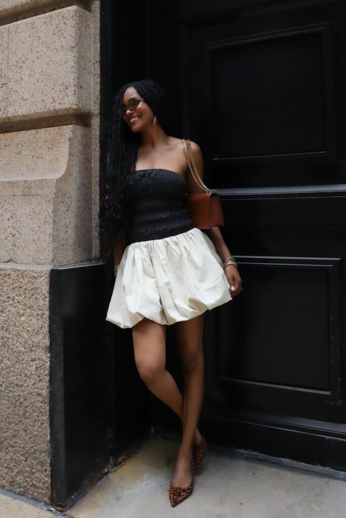 Black bandeau crop top, black biker shorts, and kitten heels