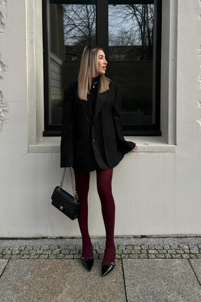 Black pinstripe blazer, burgundy tights, and black pointed-toe kitten heels