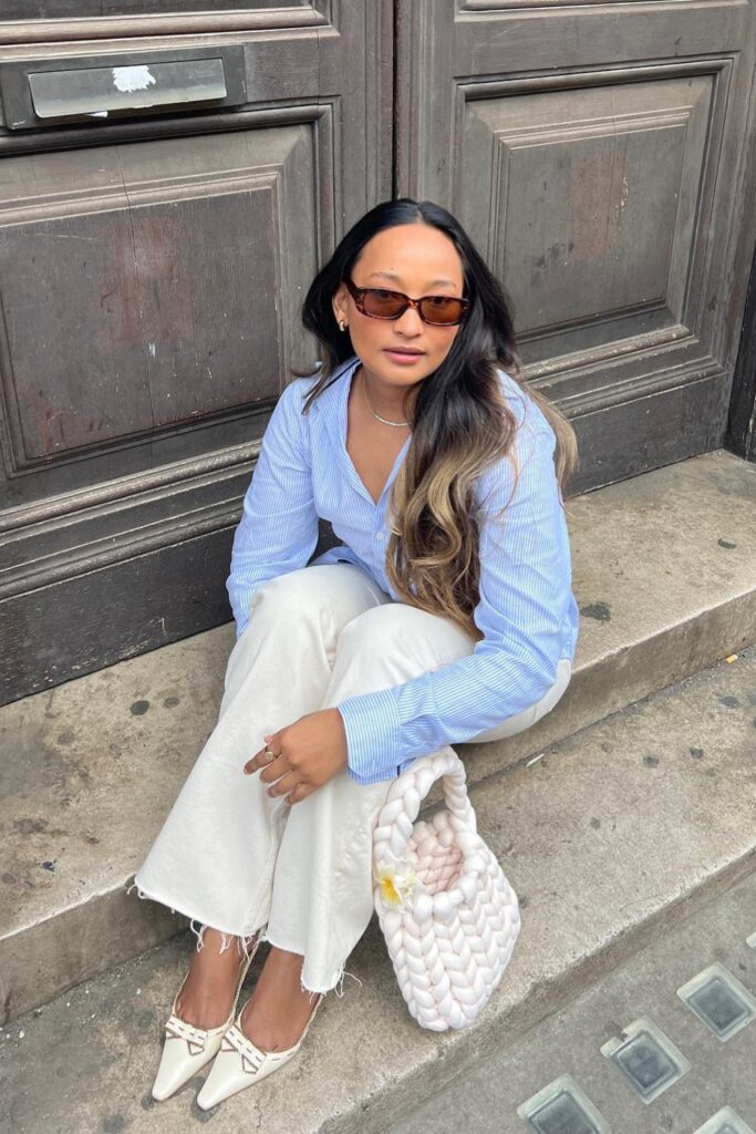 Light blue striped button-up shirt, white wide-leg jeans, and white kitten heels