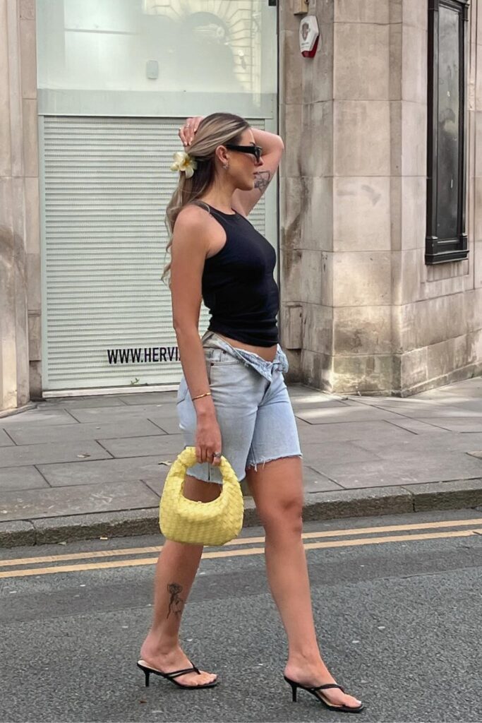 Black tank top, light wash denim shorts, and black kitten heels